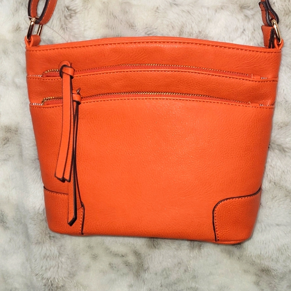 Orange purse crossbody and lots of pockets